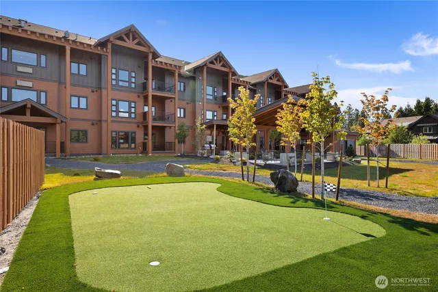 a view of an house with swimming pool and chairs