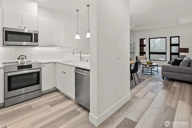 a kitchen with granite countertop a sink and a stove top oven