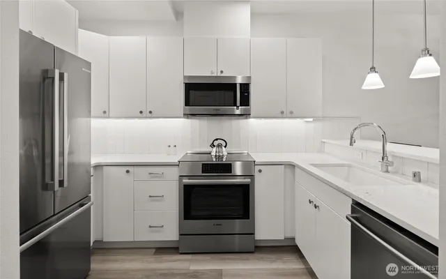 a kitchen with a sink stove and refrigerator