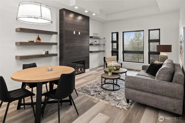 a living room with furniture wooden floor and window