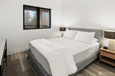 a spacious bedroom with a bed and a mirror