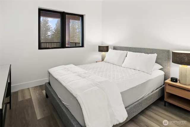 a spacious bedroom with a bed and a mirror