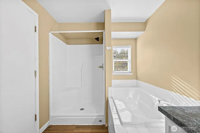 a bathroom with a granite countertop sink a toilet and a mirror