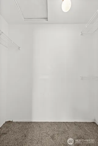 a view of storage and utility room with dryer and washer