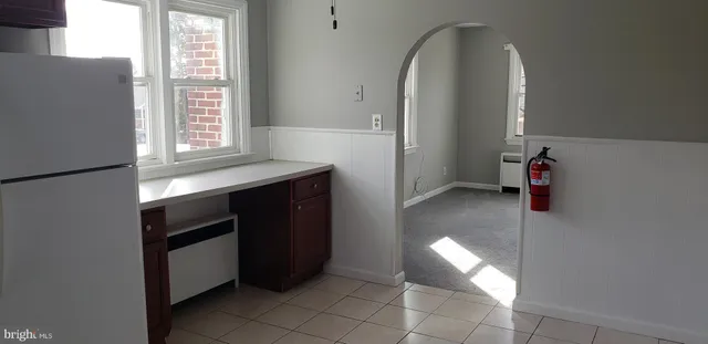 a kitchen with granite countertop a stove a sink and a refrigerator