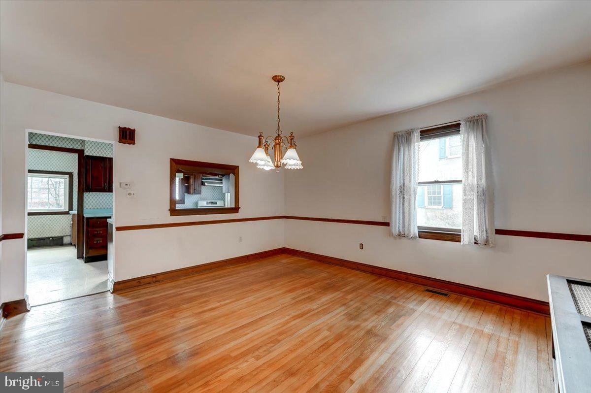 327 North Rolling Road Springfield, PA 19064 - Photo 11 of 34 a view of an empty room with window and wooden floor