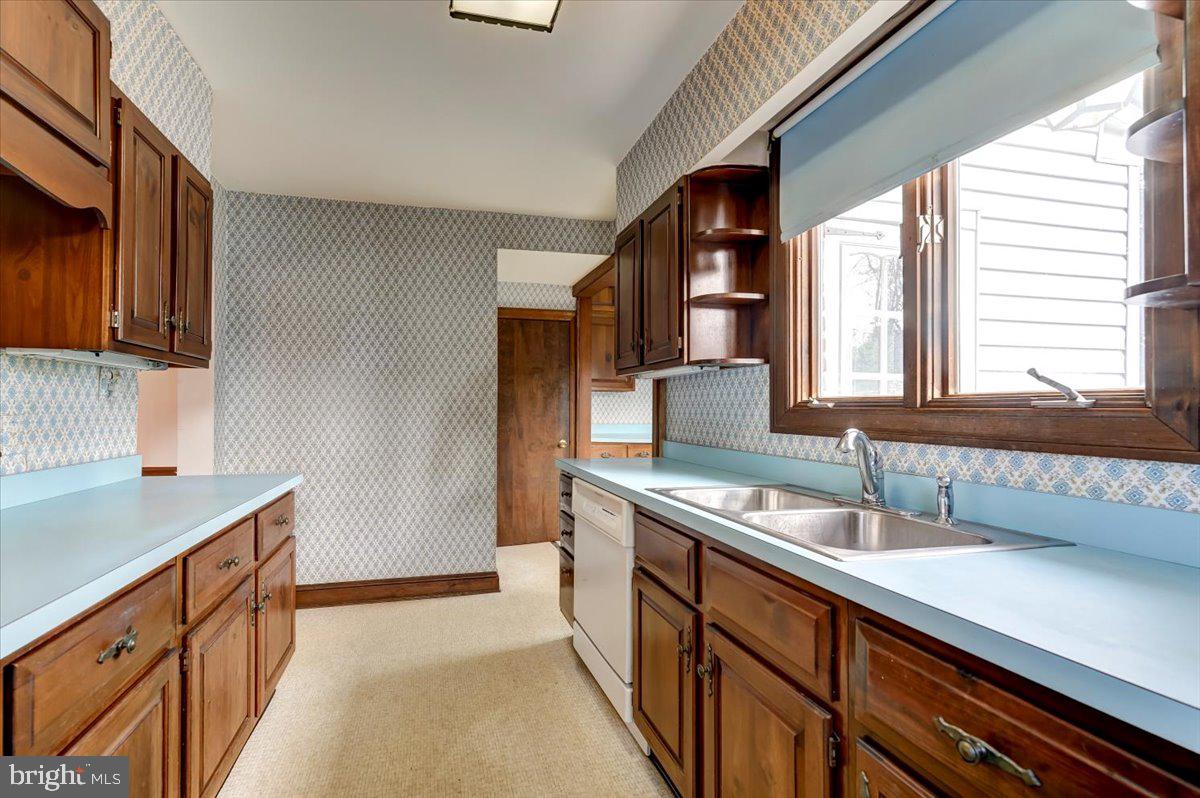 327 North Rolling Road Springfield, PA 19064 - Photo 12 of 34 a kitchen with stainless steel appliances a sink and a stove