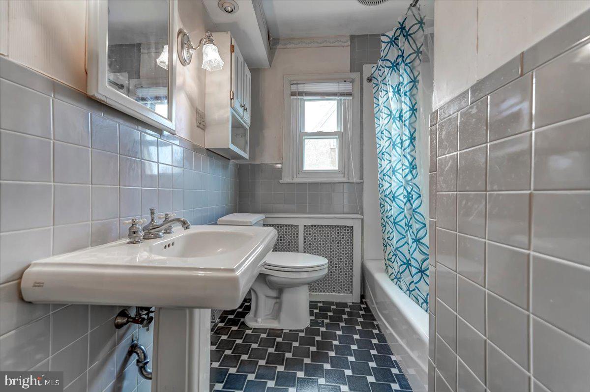 327 North Rolling Road Springfield, PA 19064 - Photo 21 of 34 a bathroom with a sink a toilet and shower