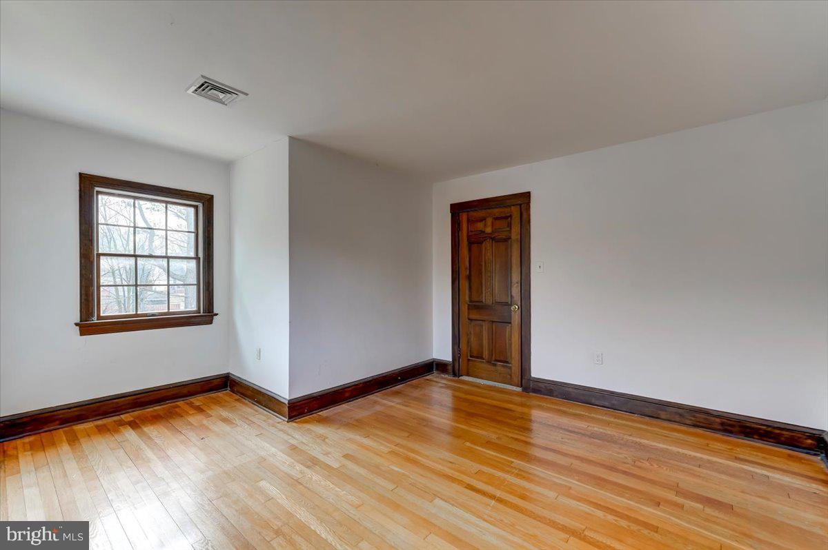 327 North Rolling Road Springfield, PA 19064 - Photo 23 of 34 a view of empty room with wooden floor and fan