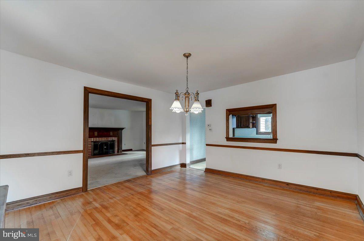327 North Rolling Road Springfield, PA 19064 - Photo 8 of 34 a room with wooden floor and chandelier