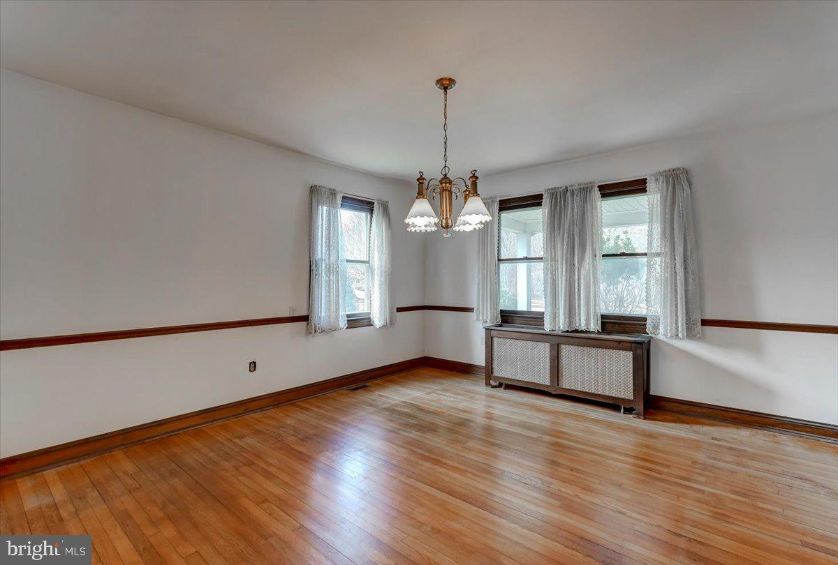 327 North Rolling Road Springfield, PA 19064 - Photo 9 of 34 a view of empty room with wooden floor and fan