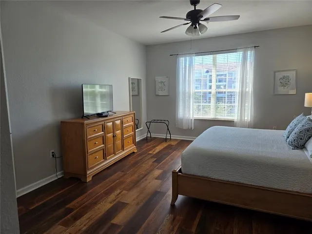 a bedroom with a bed dresser and a window
