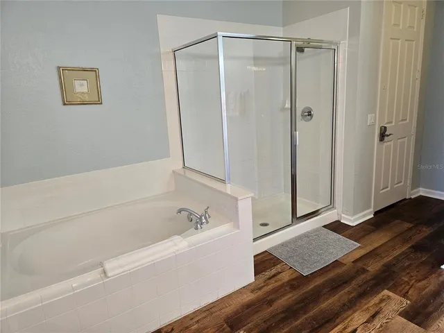 a bathroom with a bathtub and a shower