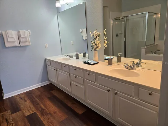 a bathroom with a double vanity sink and mirror