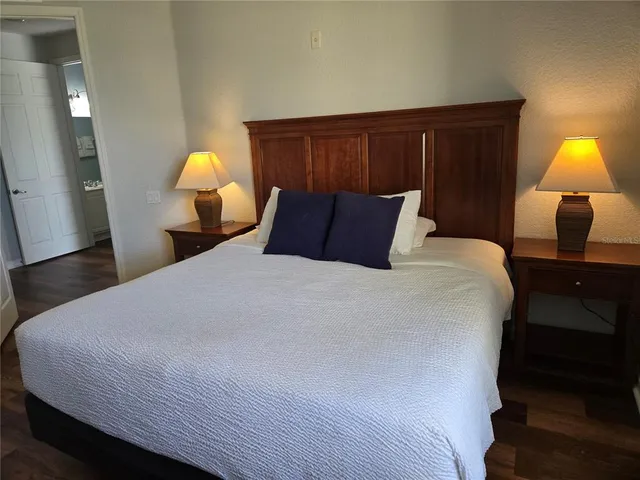 a bedroom with a bed and a lamp