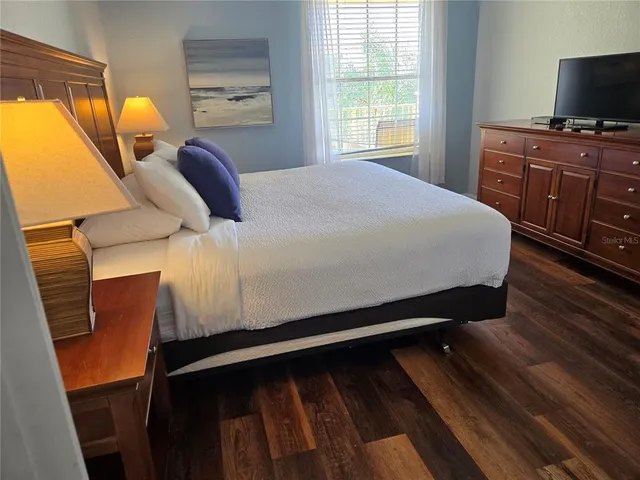 a bed sitting in a bedroom next to a window