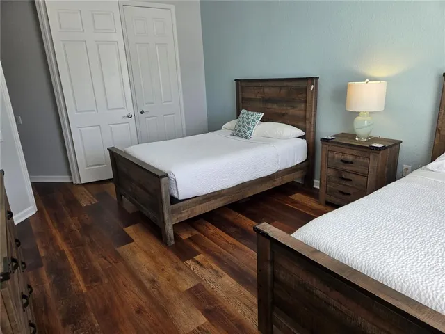 a bedroom with a bed and a night stand