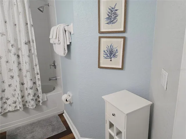 a bathroom with a shower and mirror