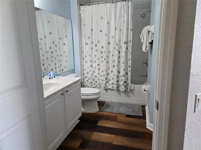 a bathroom with a bathtub shower sink and toilet