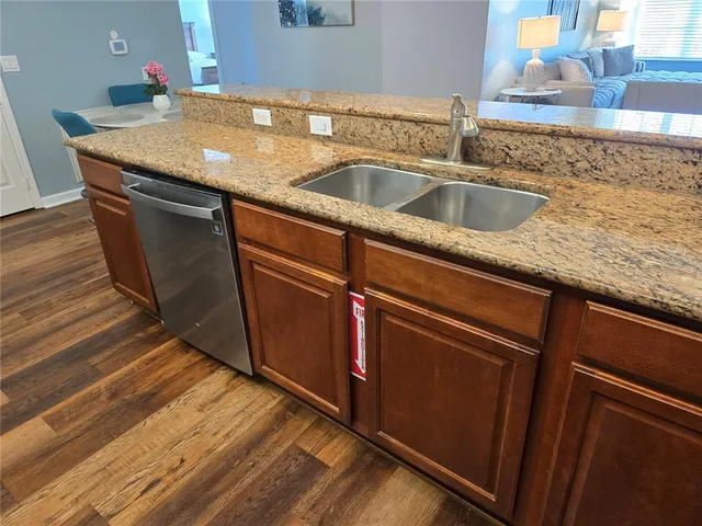 a view kitchen with granite countertop sink