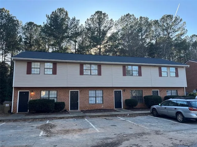 a view of a car park in front of house