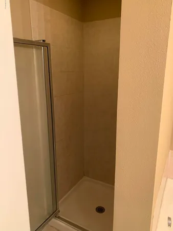 a bathroom with a glass door shower