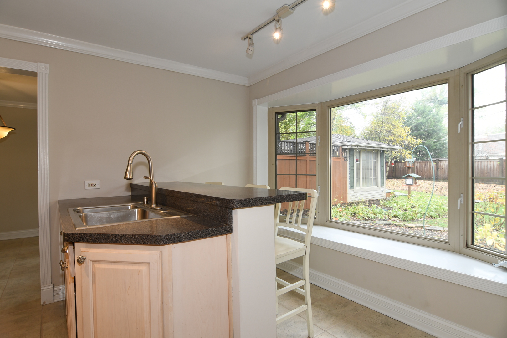 909 Warrenville Road Wheaton, IL 60189 - Photo 6 of 22 a kitchen with a table chairs and a window