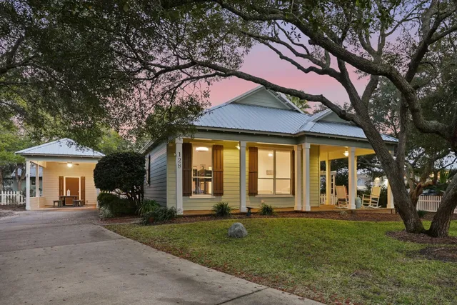 a front view of a house with a garden