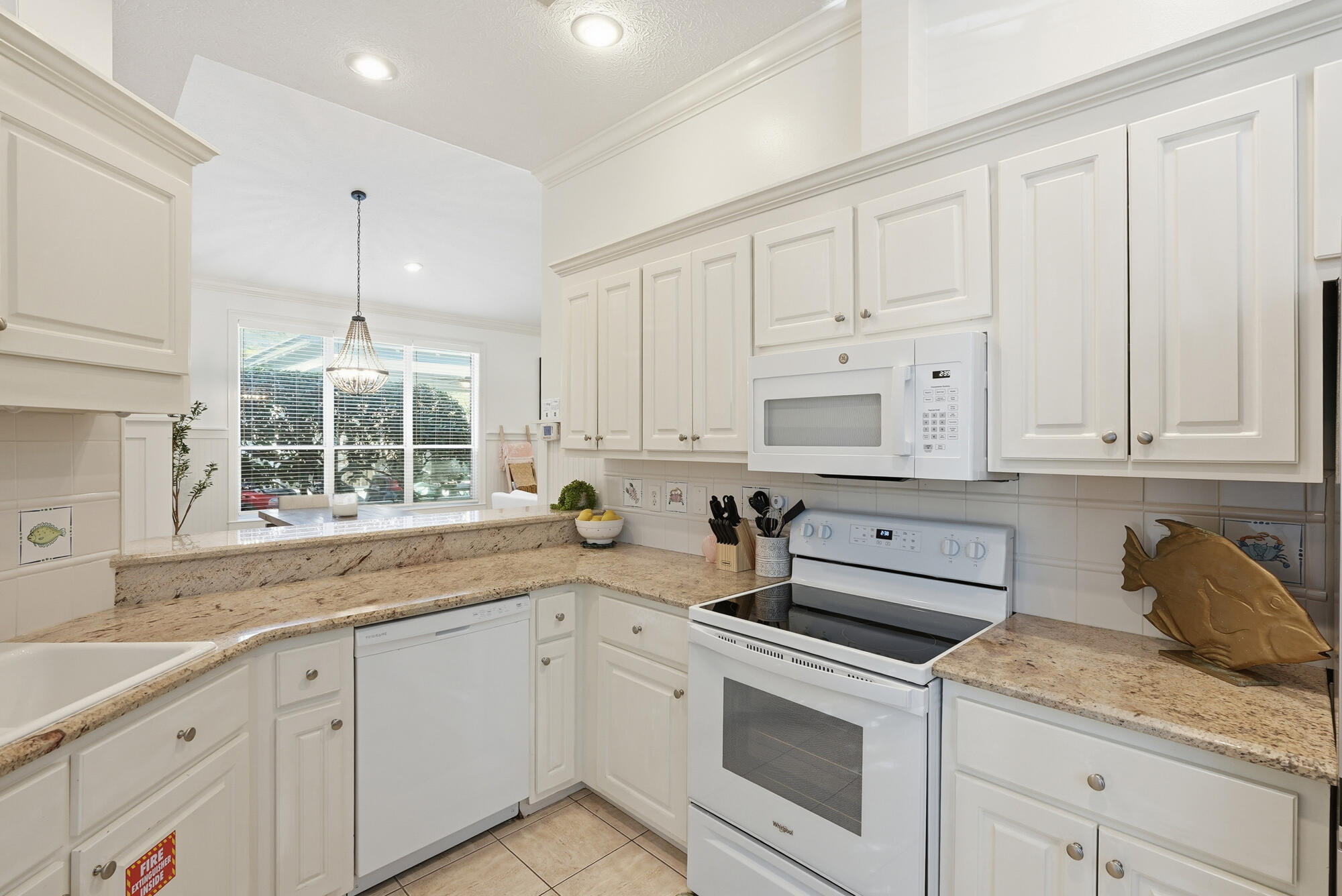 128 Seabreeze Boulevard Inlet Beach, FL 32461 - Photo 18 of 54 a kitchen with granite countertop white cabinets and white appliances
