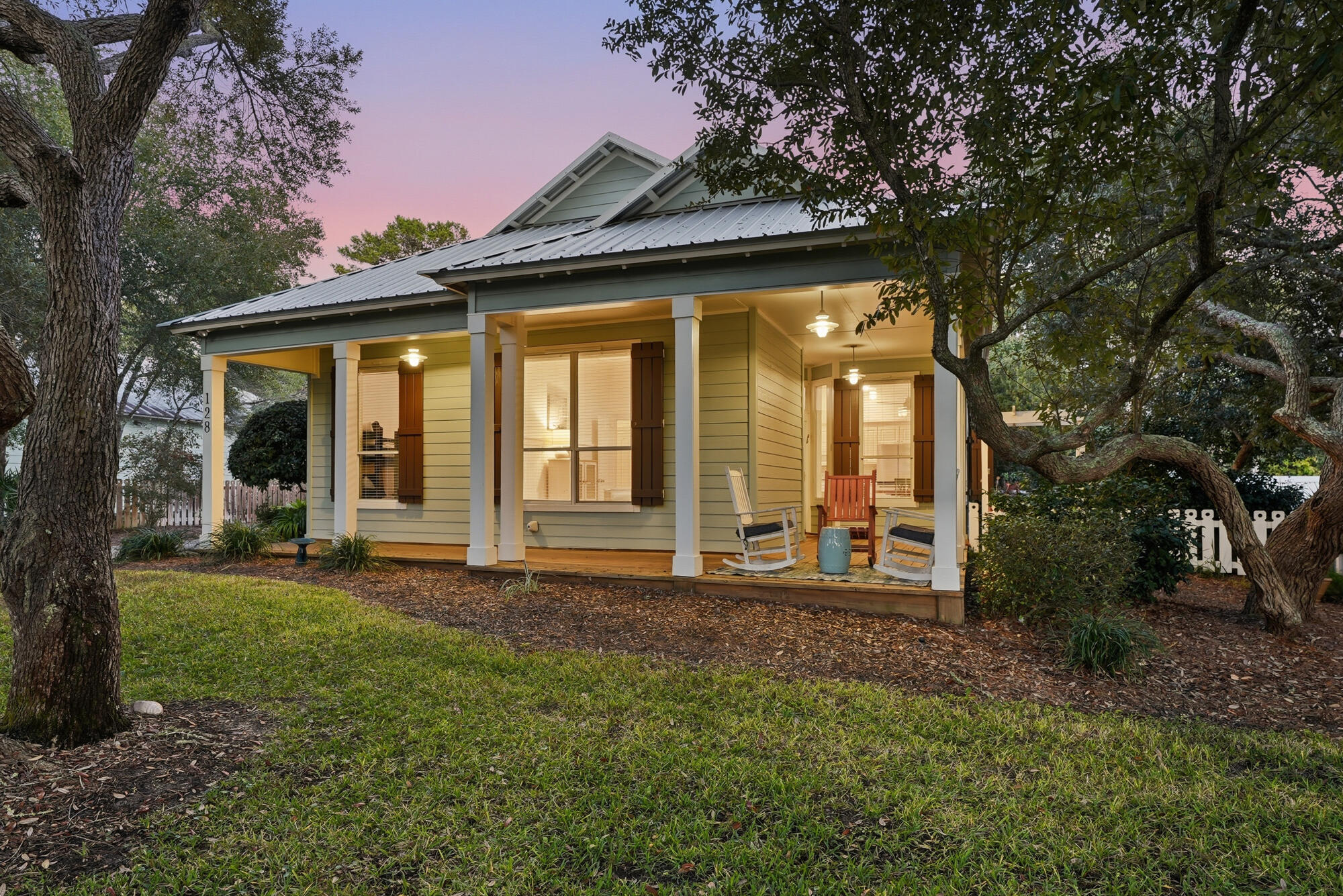 128 Seabreeze Boulevard Inlet Beach, FL 32461 - Photo 3 of 54 a front view of a house with a garden