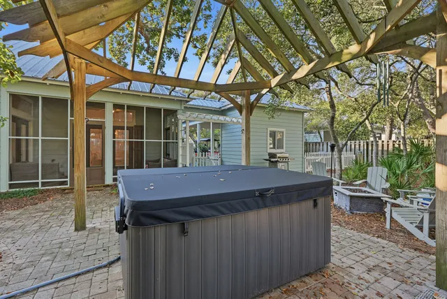 a view of a dinning table and chairs in patio of the house