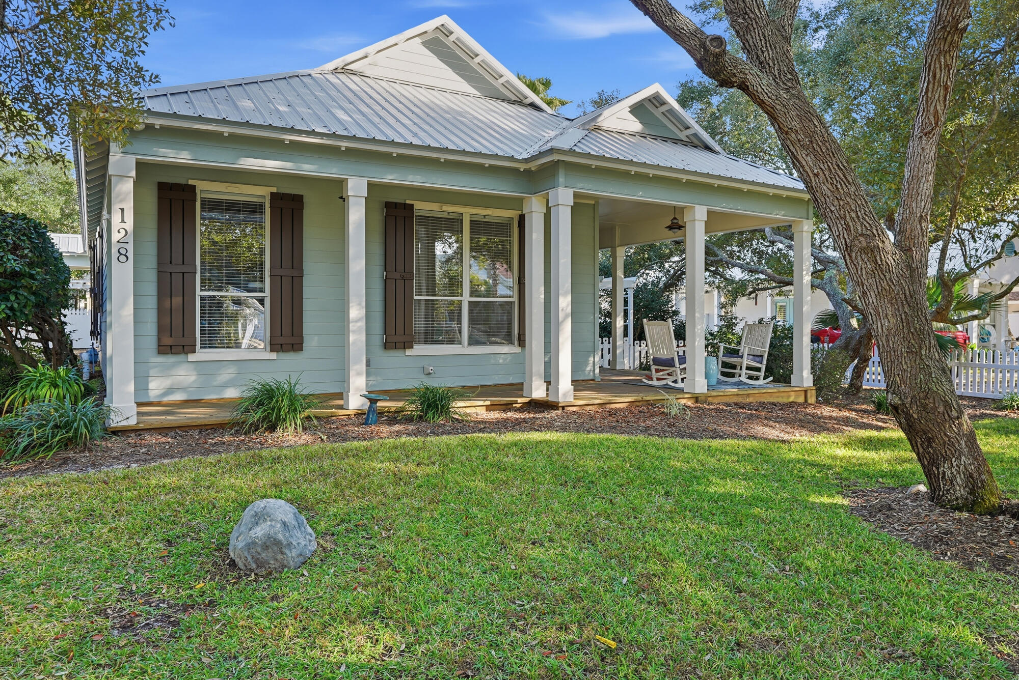 128 Seabreeze Boulevard Inlet Beach, FL 32461 - Photo 6 of 54 front view of a house with table and chairs in a yard