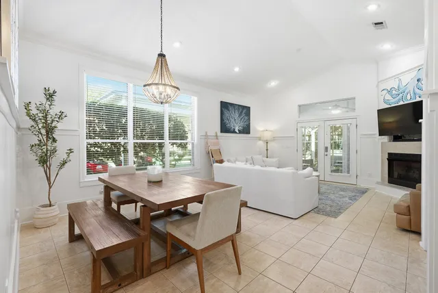 a view of a dining room with furniture and a chandelier
