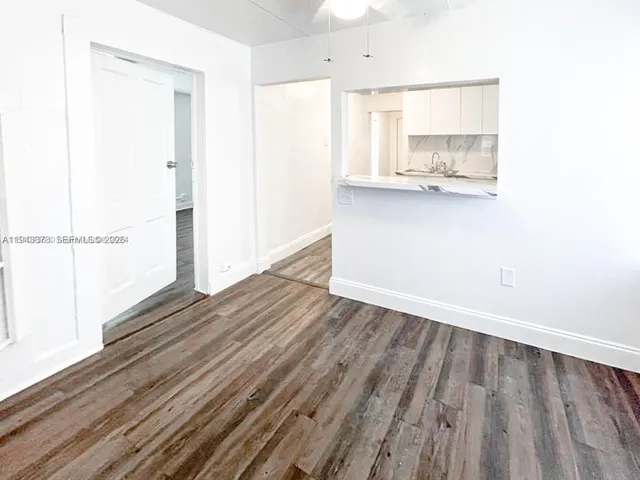 a view of a room with wooden floor