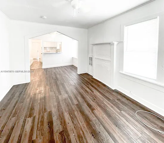 wooden floor in an empty room with a window