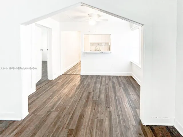 a view of a room with wooden floor