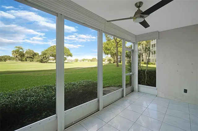 a view of a porch with furniture and garden