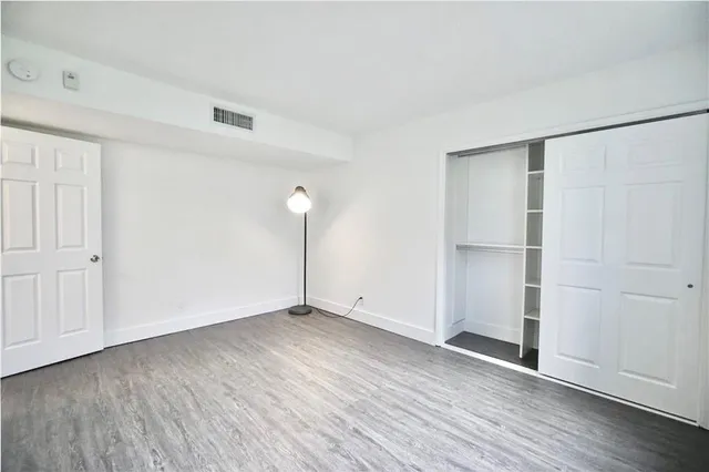 an empty room with wooden floor