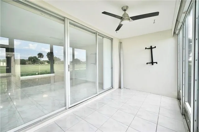 a living room with furniture and large windows