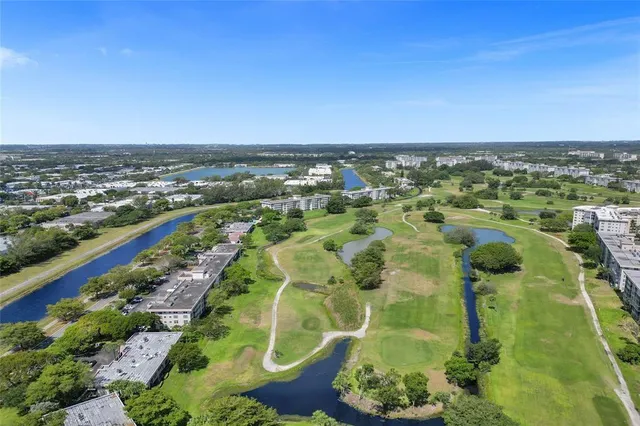 an aerial view of a houses with a yard