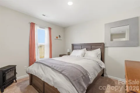 a bedroom with a bed and a tv