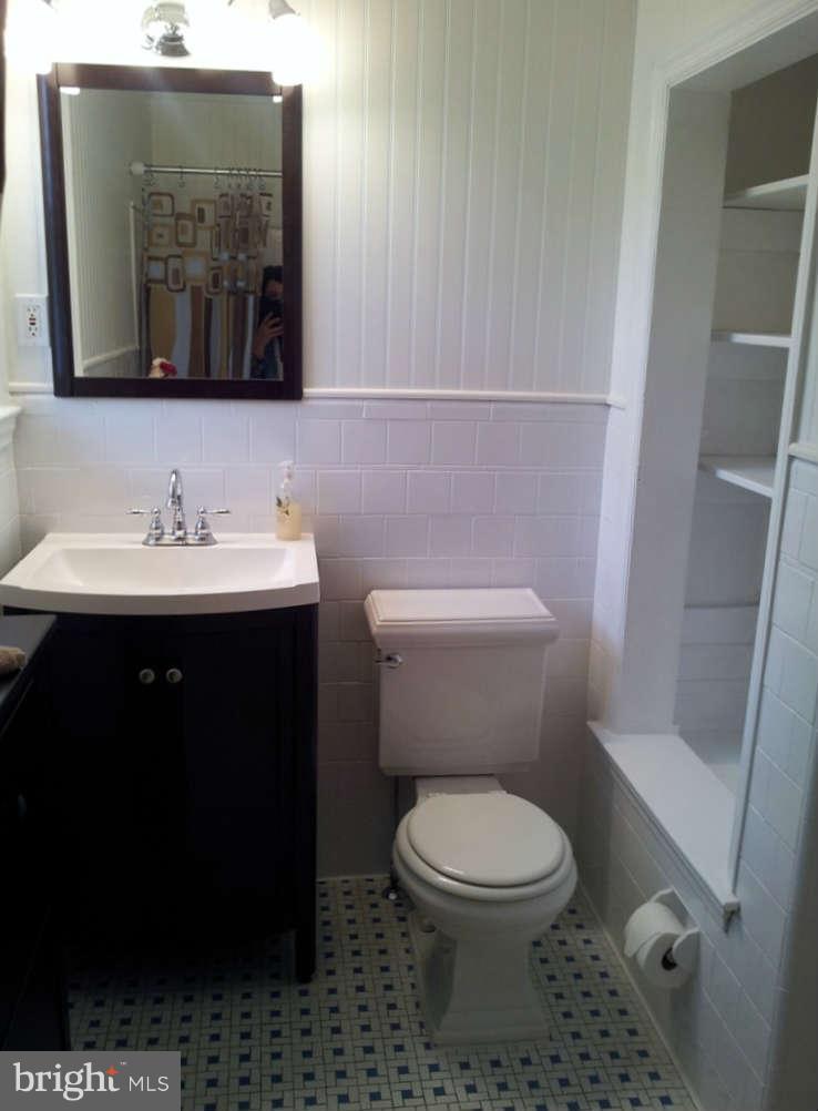 8412 Old Harford Road Baltimore, MD 21234 - Photo 17 of 25 a bathroom with a toilet sink and mirror