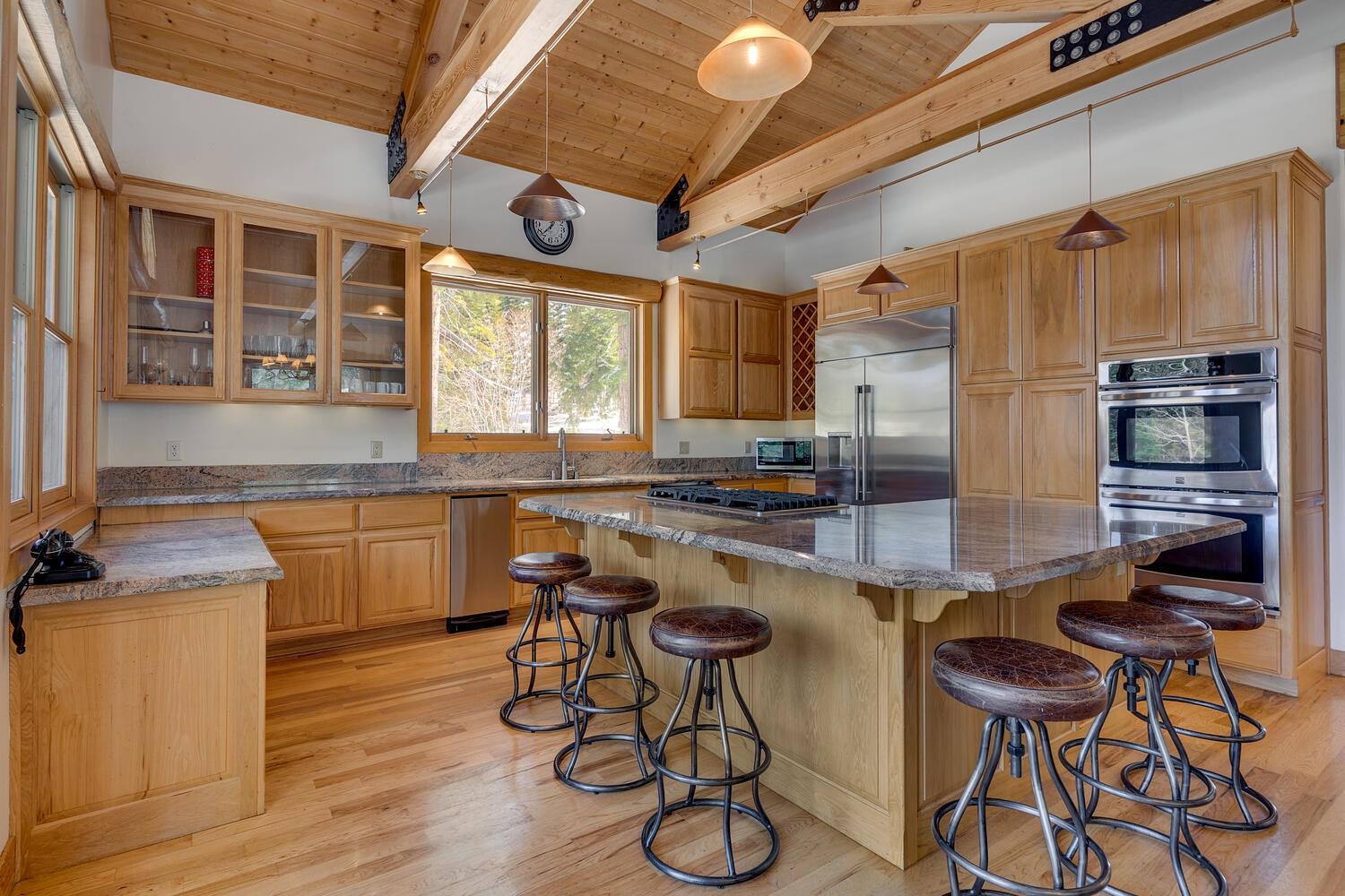 1809 Woods Point Way Northstar, CA 96161 - Photo 11 of 28 a kitchen with stools a stove a sink and a microwave