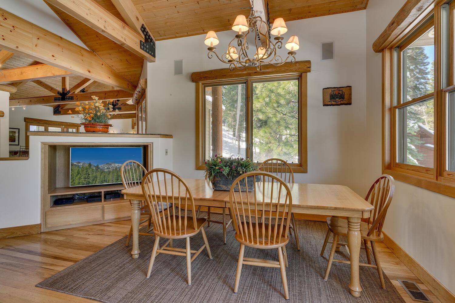 1809 Woods Point Way Northstar, CA 96161 - Photo 13 of 28 a view of a dining room with furniture a chandelier and wooden floor