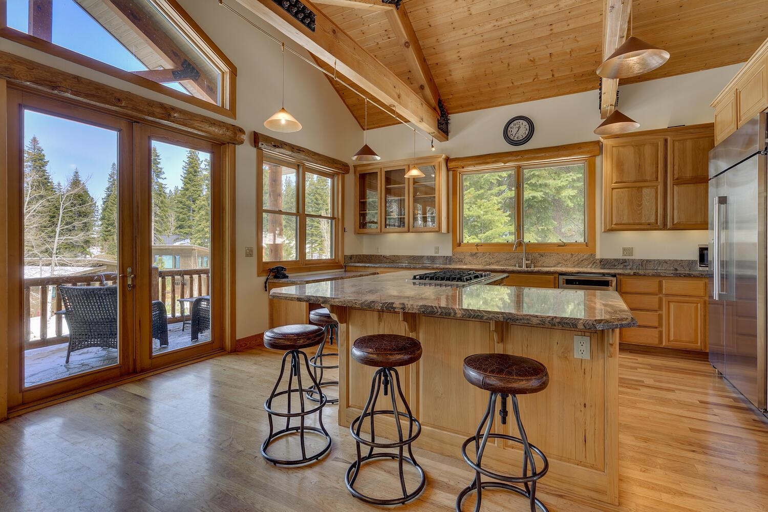 1809 Woods Point Way Northstar, CA 96161 - Photo 9 of 28 a kitchen with a table chairs stove and wooden floor