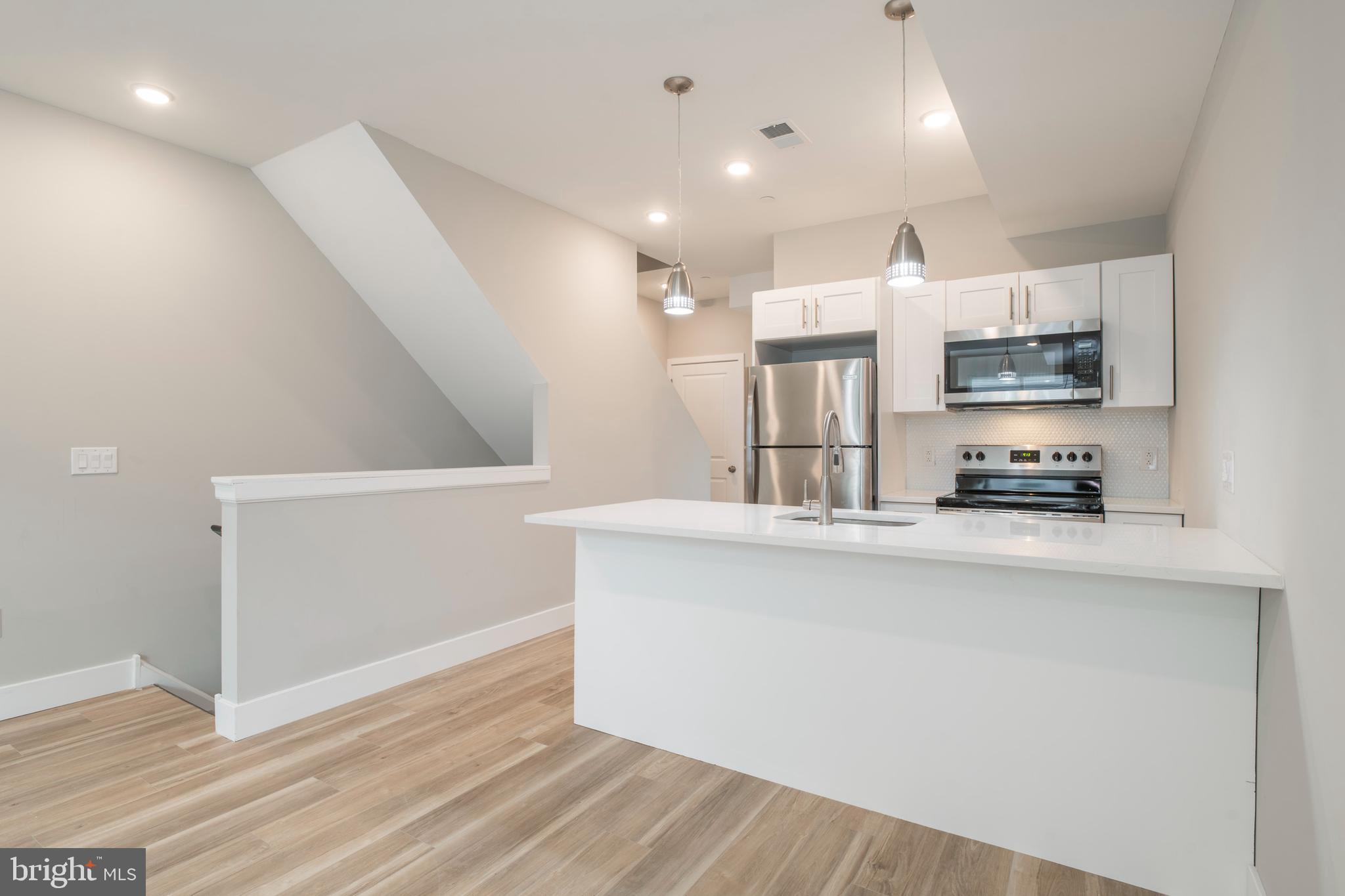 2009 North Darien Street, Unit 2 Philadelphia, PA 19122 - Photo 1 of 22 a kitchen with stainless steel appliances a refrigerator and a stove top oven