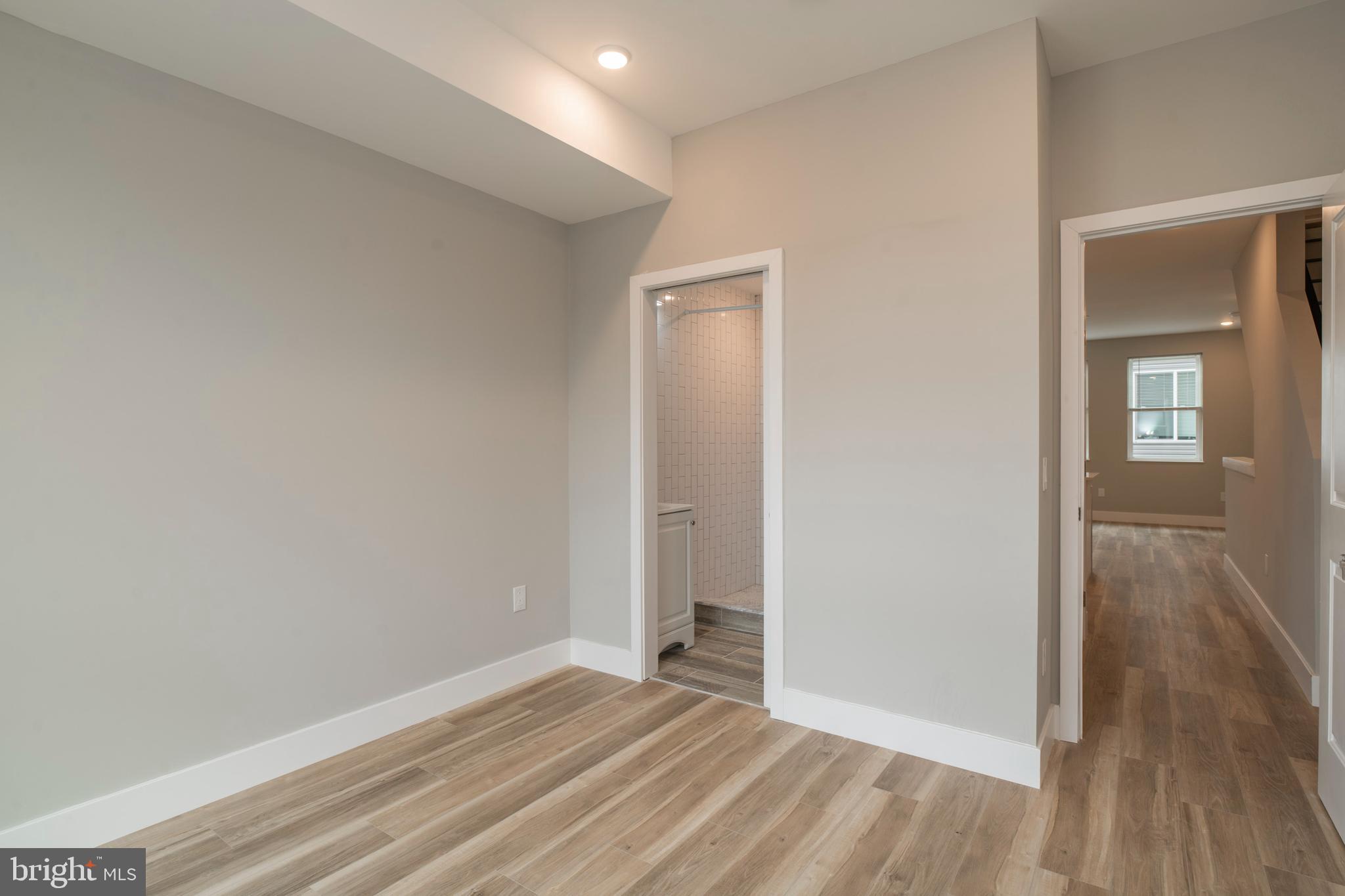 2009 North Darien Street, Unit 2 Philadelphia, PA 19122 - Photo 11 of 22 a view of an empty room with wooden floor and a window