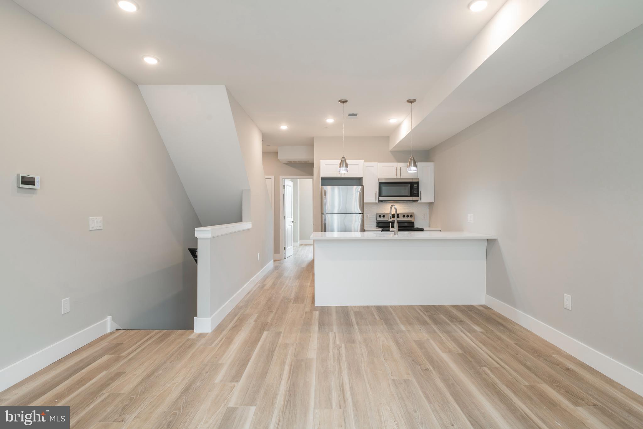 2009 North Darien Street, Unit 2 Philadelphia, PA 19122 - Photo 4 of 22 a view of kitchen and hall with wooden floor