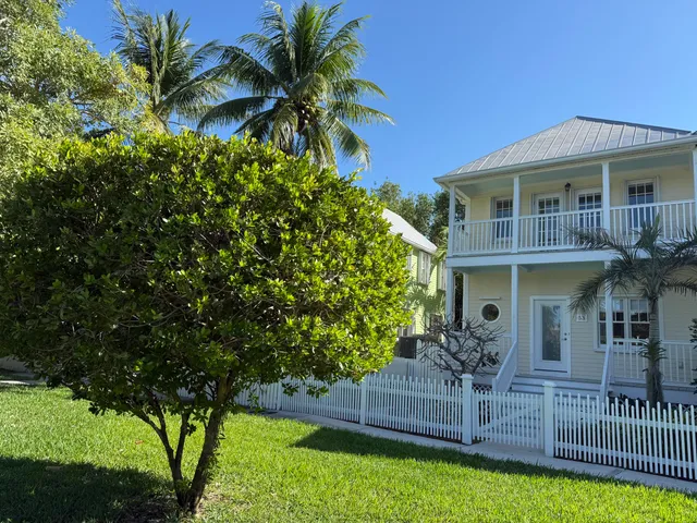 a front view of house with yard and outdoor seating