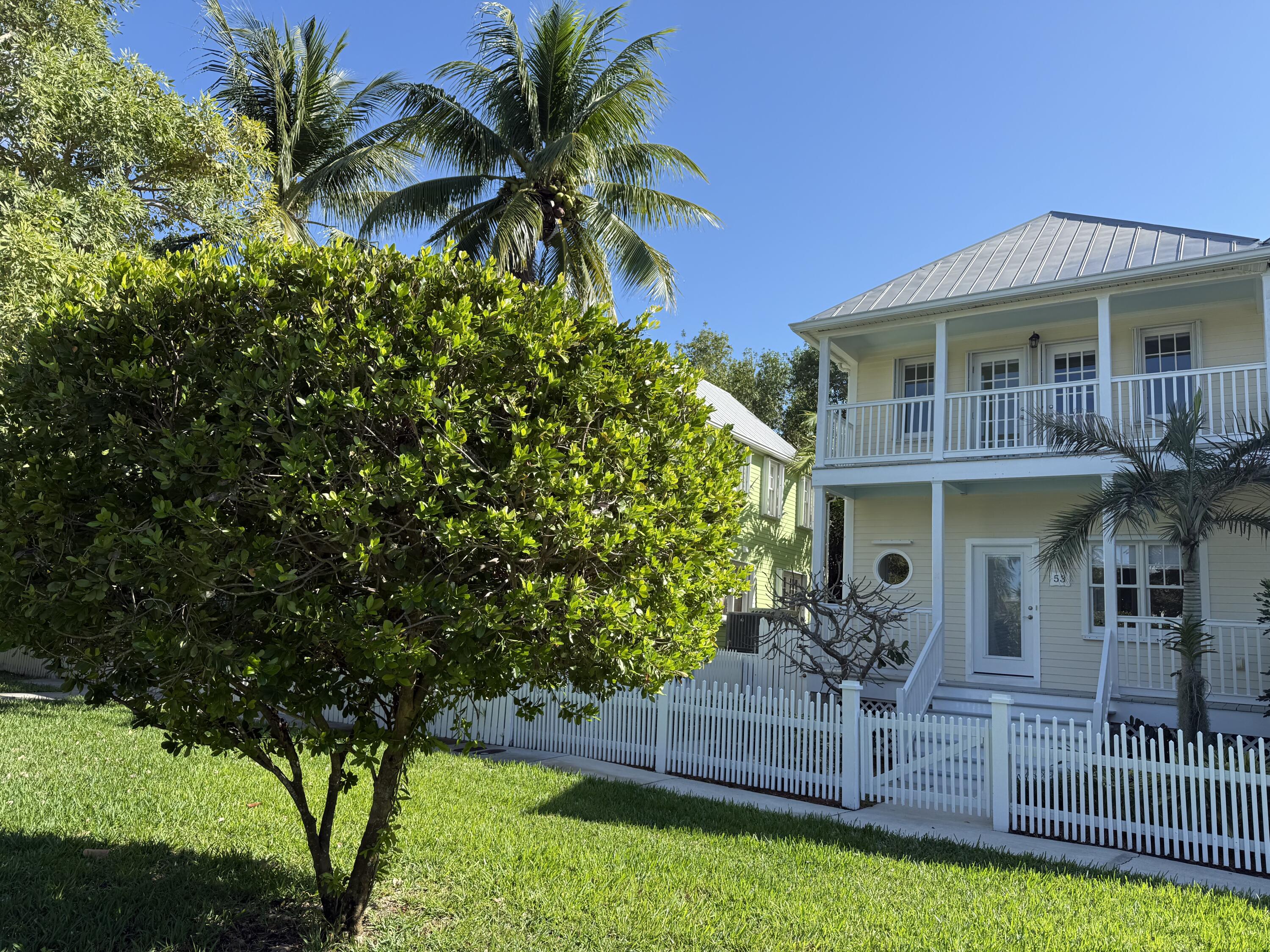 a front view of house with yard and outdoor seating